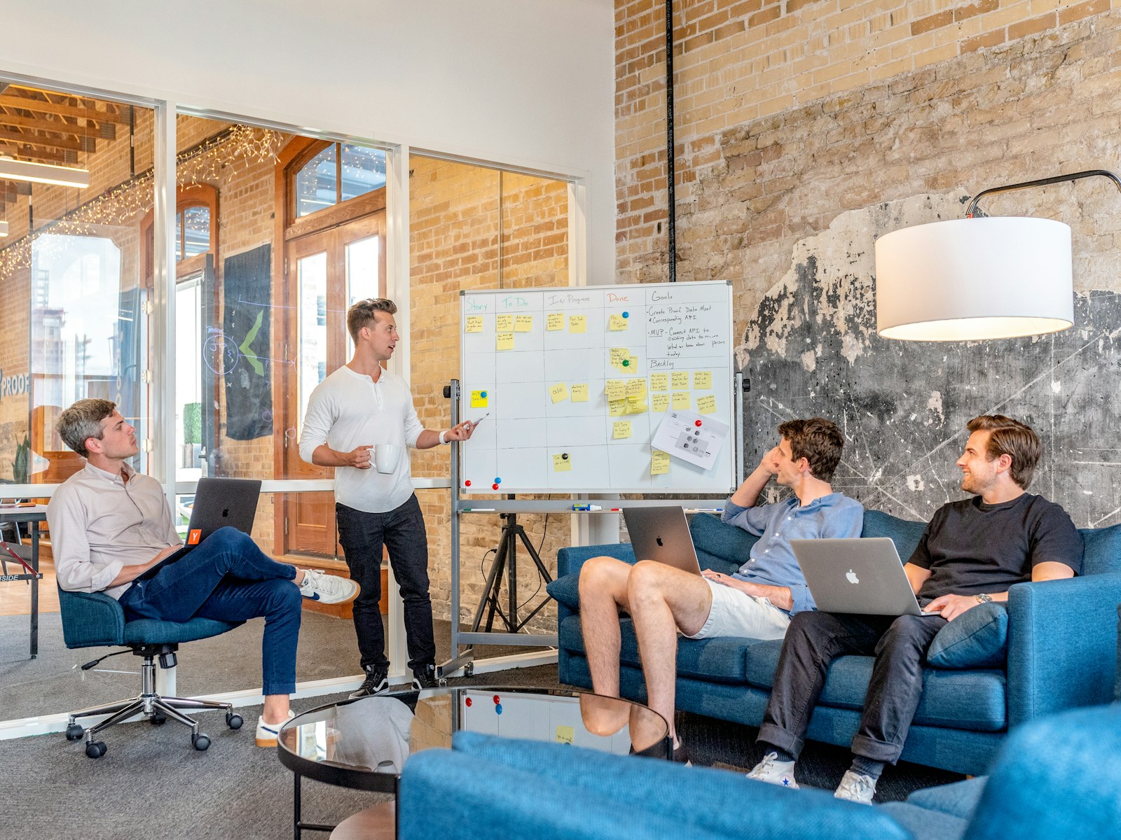 Founders whiteboarding around a laptop